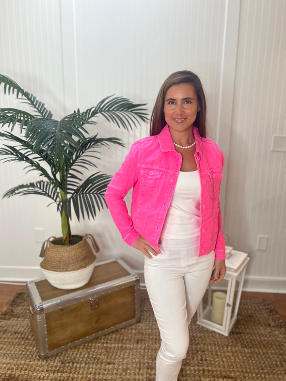 Model with hand on hip wearing hot pink linen jacket