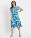 Smiling model in the Jude Connally Libby Dress - Kaleidoscope Floral Iris