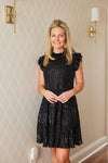 Indoor model in the Sail to Sable Ruffle Neck Dress - Black Sequin