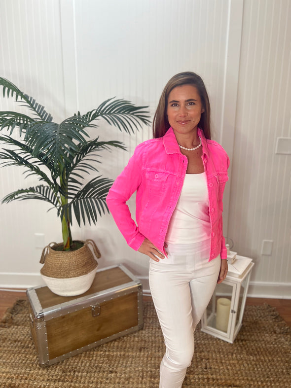 Model in white jeans and top wearing hot pink linen button down jacket