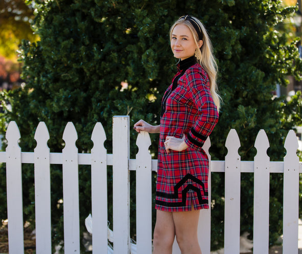 Model with hand on her hip in Sail to Sable Tunic Dress in Red Plaid