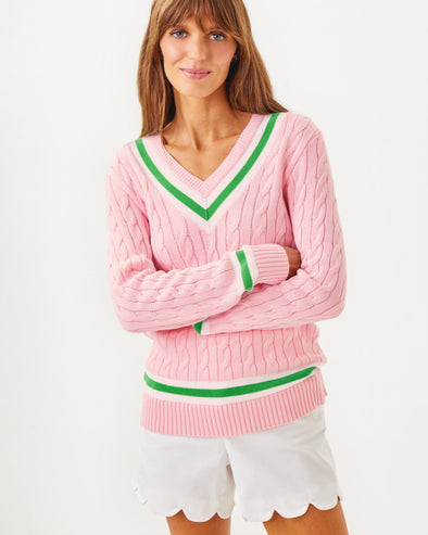 Front view of the Lilly Pulitzer Brockton Sweater. A light pink varsity style sweater with green accent stripes around the v neck collar, wrists, and bottom hem