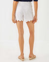 Back view of the Lilly Pulitzer Buttercup Mid-Rise Short in Resort White. White scallop hem shorts with a gold button closure 
