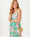 Smiling model in the Model in the Lilly Pulitzer Teresa Maxi Dress - Multi - Plumes In Bloom. A tiered maxi dress with a knee high slit and spaghetti straps