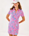 Smiling model in the Lilly Pulitzer Dune Short Sleeve Dress - Rousseau Pink - Barefoot Beachcombers. A hot pink mini dress with short sleeves and a collar, with light blue beach motifs 