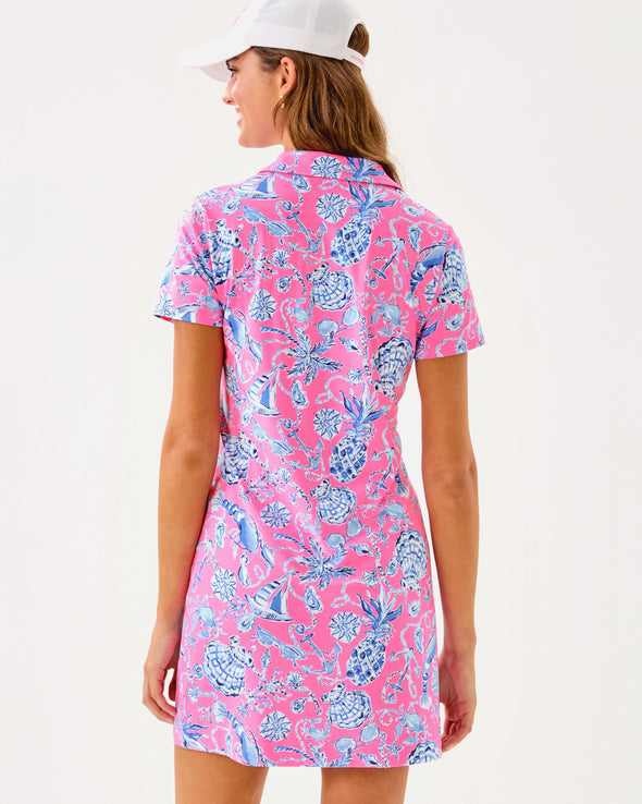 Back view of smiling model in the Lilly Pulitzer Dune Short Sleeve Dress - Rousseau Pink - Barefoot Beachcombers. A hot pink mini dress with short sleeves and a collar, with light blue beach motifs 