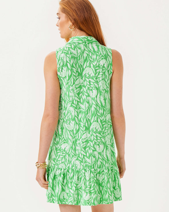 Back view of the Lilly Pulitzer Riegan Dress - Fauna Green. A sleeveless mini dress with a mock neck and ruffle at the bottom hem, in a green floral pattern 
