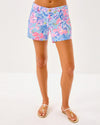 Smiling model in the Lilly Pulitzer Callahan Stretch Short - Elephant Splash. Light blue shorts with pink, blue, yellow, and purple details 
