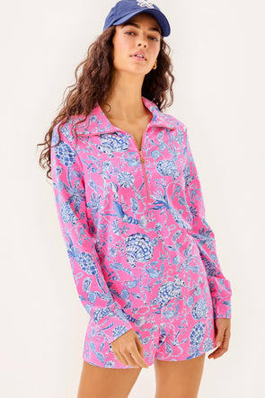 Model in the Lilly Pulitzer Eleni Pullover - Rousseau Pink - Barefoot Beachcombers. A hot pink 1/2 zip pullover with blue and white shells, pineapples, anchors, and other beachy motifs 
