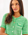 Front view of details of Lilly Pulitzer Theodorah Sweater Dress - Fauna Green Metallic Marl. A mini dress with short sleeves, in a green and slightly metallic knit. 