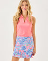Smiling model in the Lilly Pulitzer Bessie Skort - Elephant Splash. A high rise athletic skirt with pleats at the bottom hem