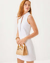 Model in the Lilly Pulitzer Elsey Shift - Resort White - Leafy Knit Pucker Jacquard. A mini sleeveless dress with a ruffled collar and v neck