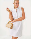 Smiling model in the Lilly Pulitzer Elsey Shift - Resort White - Leafy Knit Pucker Jacquard. A mini sleeveless dress with a ruffled collar and v neck
