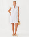 Smiling model in the Lilly Pulitzer Elsey Shift - Resort White - Leafy Knit Pucker Jacquard. A mini sleeveless dress with a ruffled collar and v neck