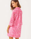 Back view of model in the Lilly Pulitzer Daphnie Tunic Dress - Rousseau Pink - Tulip To Tango Enginee. A 3/4 sleeve mini dress with a collar and v neck with button closure 