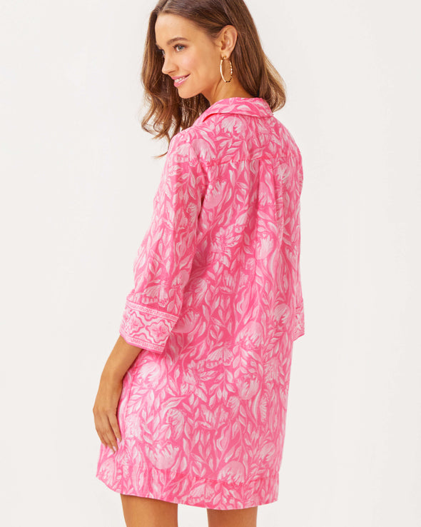 Back view of model in the Lilly Pulitzer Daphnie Tunic Dress - Rousseau Pink - Tulip To Tango Enginee. A 3/4 sleeve mini dress with a collar and v neck with button closure 