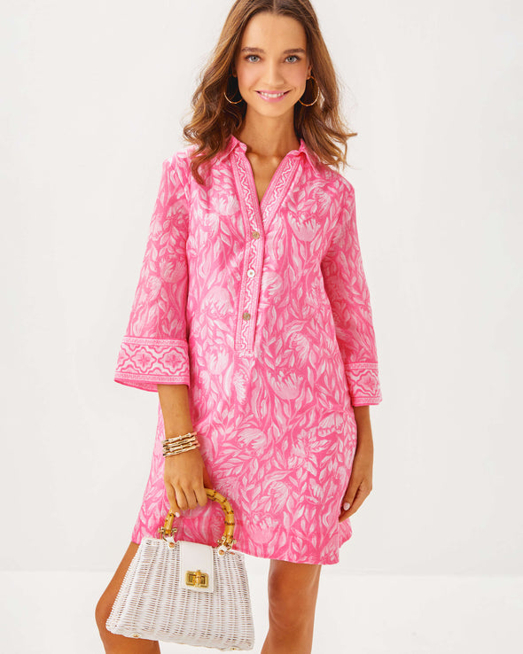 Front view of the Model in the Lilly Pulitzer Daphnie Tunic Dress - Rousseau Pink - Tulip To Tango Enginee. A 3/4 sleeve mini dress with a collar and v neck with button closure 