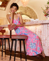 Smiling model in the Lilly Pulitzer Verica Silk Maxi Dress - Rousseau Pink - Oversized Barefoot Beachcombers. A spaghetti strap, hot pink maxi dress with blue shell details 