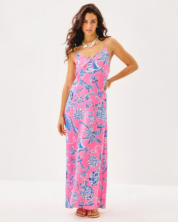 Model in the Lilly Pulitzer Verica Silk Maxi Dress - Rousseau Pink - Oversized Barefoot Beachcombers. A spaghetti strap, hot pink maxi dress with blue shell details 