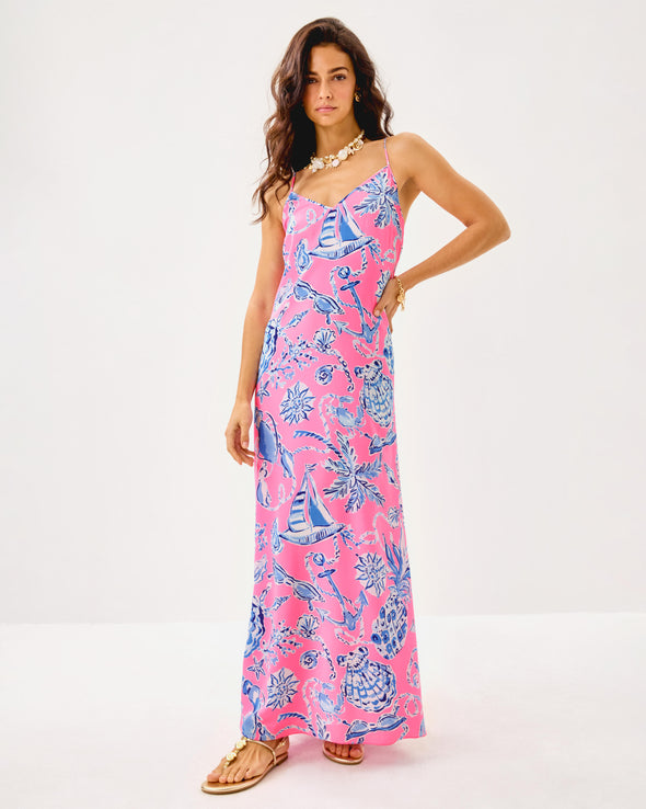 Model in the Lilly Pulitzer Verica Silk Maxi Dress - Rousseau Pink - Oversized Barefoot Beachcombers. A spaghetti strap, hot pink maxi dress with blue shell details 