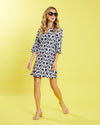 Full view of model wearing Jude Connally Megan Dress in JC Ikat Navy with yellow background