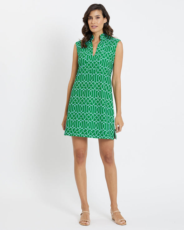 Brunette model wearing short sleeveless green and white print dress