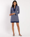 Woman wearing a blue and white striped dress on a white background
