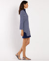 Woman wearing a blue and white striped dress on a white background