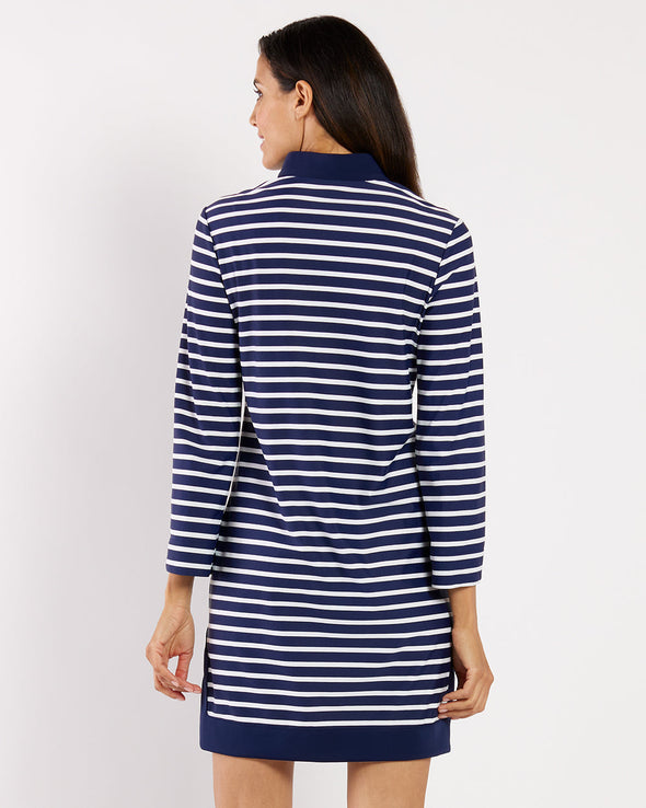 Woman wearing a blue and white striped dress on a plain background