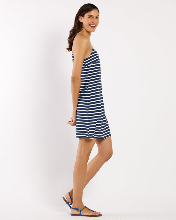 Woman wearing a blue and white striped dress on a white background
