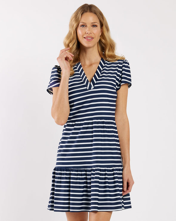 Model in a navy and white striped dress with a v neck and short sleeves