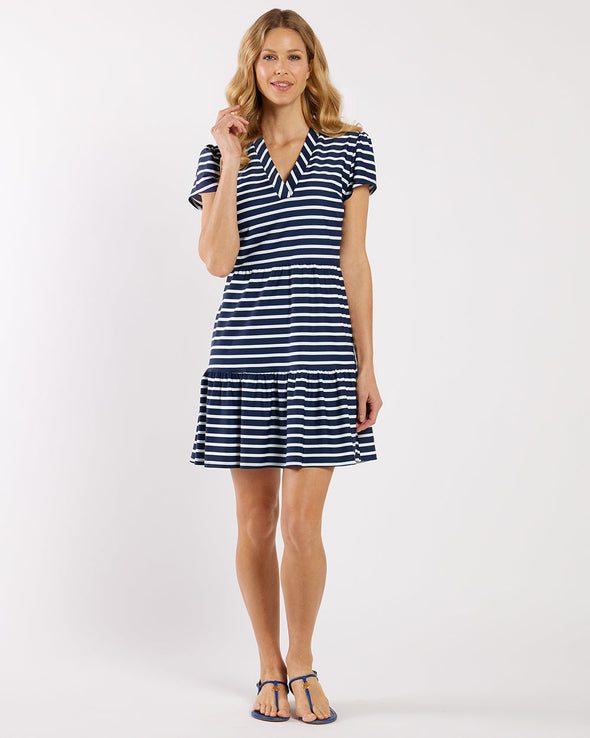 Woman wearing a navy and white striped dress on a white background