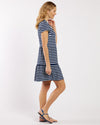 Side view of model in a navy and white striped dress