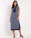 Woman wearing a navy and white striped dress on a white background