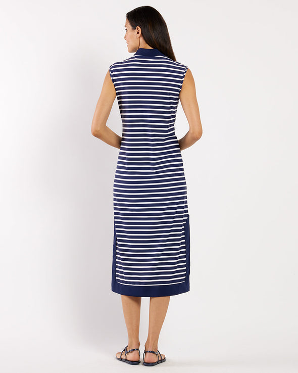 Woman wearing a navy and white striped dress on a white background