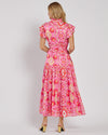 Back view of the Jude Connally Mirabella Dress in Gilded Garden Peony Pink Gold. A pink orange and gold midi dress with flutter sleeves and tie belt with a floral/geometric pattern