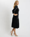 Side view of model wearing Jude Connally Maggie Velvet Midi Dress in Black with white background