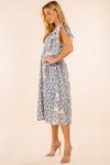 Full body view of model with hand on hip in the Providence Eyelet Midi Dress. A midi length dress with blue eyelet detailing, with puffy sleeves and a zip closure