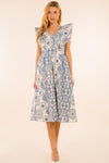 Full body view of model in the Providence Eyelet Midi Dress. A midi length dress with blue eyelet detailing, with puffy sleeves and a zip closure