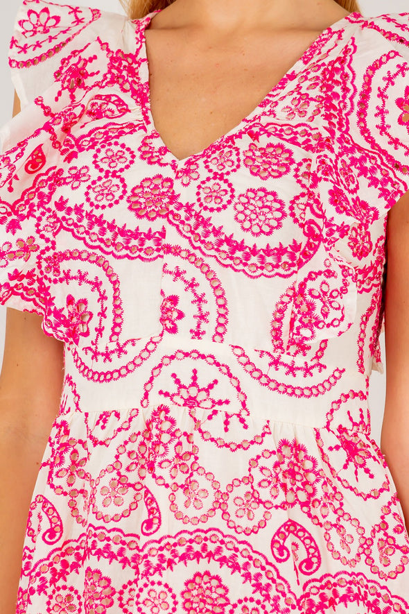 Close up view of the Tisbury Eyelet Midi Dress. A midi length dress with pink eyelet detailing, and puff sleeves