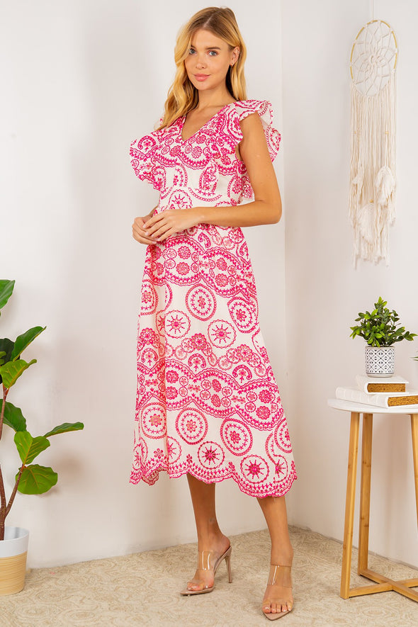 Full body view of the Tisbury Eyelet Midi Dress. A midi length dress with pink eyelet detailing, and puff sleeves