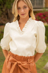 Model outside wearing the Voy Sloane Puff Sleeve Top in Cream