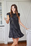 Model twirling in the Sail to Sable Ruffle Neck Dress - Black Sequin
