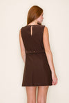 Back view of model in a sleeveless brown dress with a boatneck neckline, a belt with gold detailing, and keyhole zipper on back 
