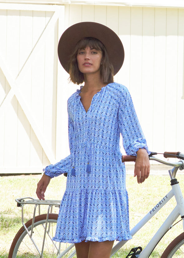 Outdoor model leaning against a bike  in the xCabana Life Sullivans Island Tiered Ruffle Dress