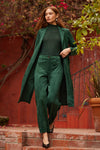 Woman in a knee length green suede jacket 