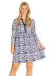 Model in a mini length, 3/4 sleeve dress with a navy floral pattern on a white background