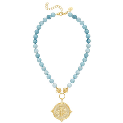 A flat view of the Susan Shaw Nellie Bee Necklace. Blue beads with a gold bee pendant