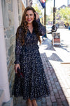 Outdoor model in the Sail to Sable Smocked Midi Dress - Navy Clip Dot