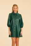 Model is wearing the Dolce Cabo Soft Vegan Leather Dress in Forest Green. A mini shift silhouette with soft faux leather, 3/4 puff sleeves, and front button detailing